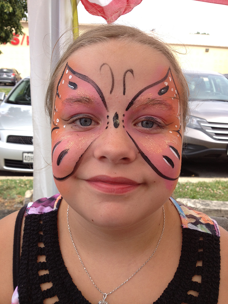 Girl with a butterfly painted on her face