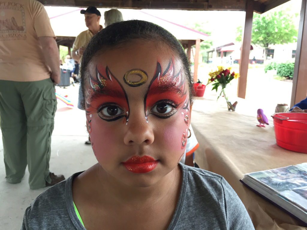 Girl with her face painted as a princess